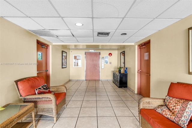 7801 Abbott Ave Unit 307, Miami Beach, FL 33141 - living area with elevator, a paneled ceiling, and light tile patterned floors