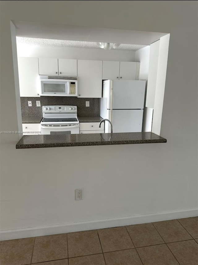 4659 NW 97th Ct Unit 35, Doral, FL 33178 - kitchen with white appliances, white cabinetry, tasteful backsplash, and tile patterned floors