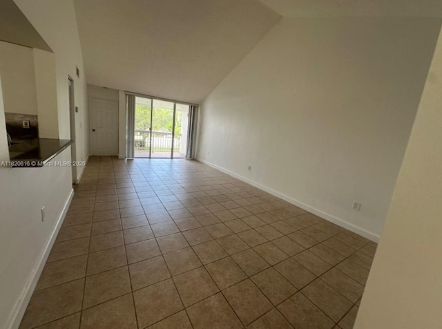 4659 NW 97th Ct Unit 35, Doral, FL 33178 - unfurnished living room with tile patterned flooring and lofted ceiling