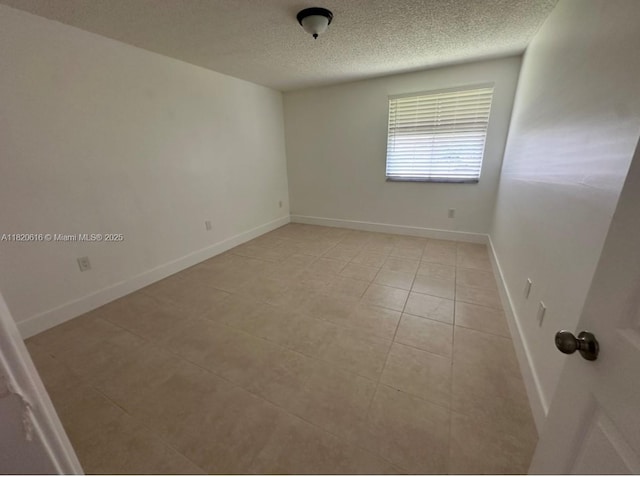 4659 NW 97th Ct Unit 35, Doral, FL 33178 - unfurnished room featuring a textured ceiling and light tile patterned flooring