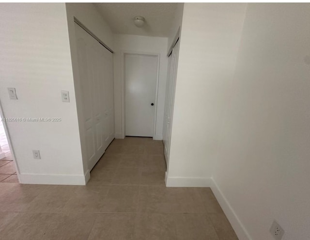 4659 NW 97th Ct Unit 35, Doral, FL 33178 - corridor featuring light tile patterned floors and baseboards