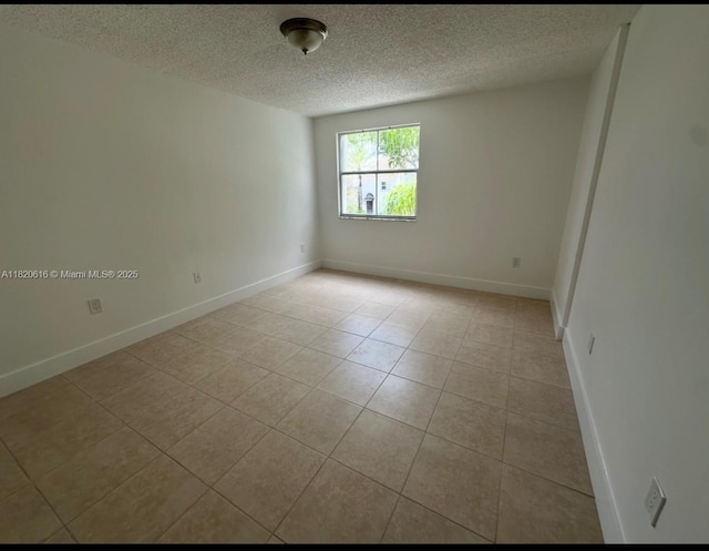 4659 NW 97th Ct Unit 35, Doral, FL 33178 - spare room with a textured ceiling and light tile patterned flooring