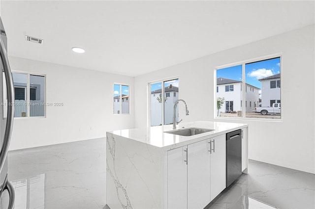 28841 SW 162nd Ave Unit A, Miami, FL 33033 - kitchen featuring marble tiled floors, stainless steel appliances, a kitchen island with sink, light stone counters, and white cabinetry