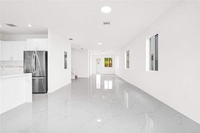28841 SW 162nd Ave Unit A, Miami, FL 33033 - unfurnished living room featuring light marble finish floors and recessed lighting