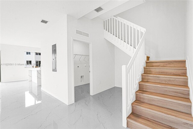 28841 SW 162nd Ave Unit A, Miami, FL 33033 - stairs with marble tiled flooring, electric panel, and a towering ceiling