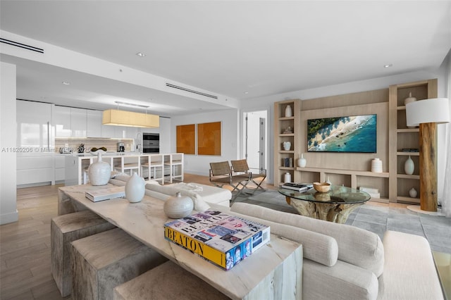 102 24th St Unit Ph-1706, Miami Beach, FL 33139 - living area featuring built in features, light wood-style floors, and recessed lighting