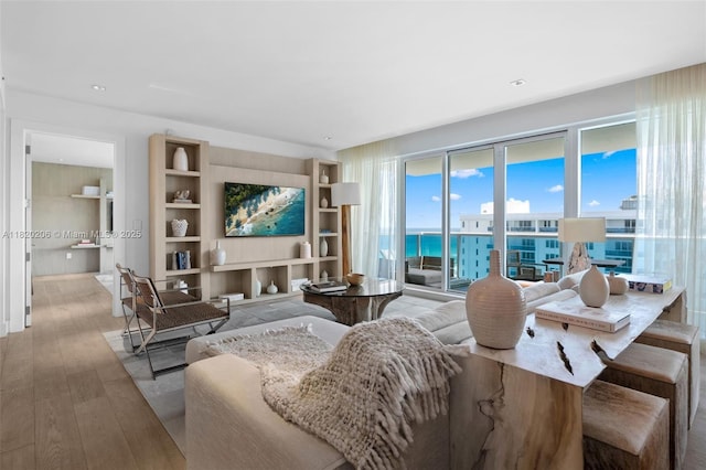 102 24th St Unit Ph-1706, Miami Beach, FL 33139 - living room featuring hardwood / wood-style floors and built in features