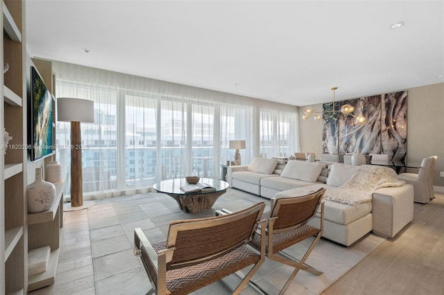 102 24th St Unit Ph-1706, Miami Beach, FL 33139 - living room with a chandelier and light wood-style flooring