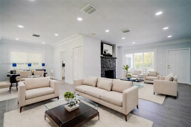 8390 SW 64th St, Miami, FL 33143 - living area featuring wood finished floors, ornamental molding, recessed lighting, and a stone fireplace