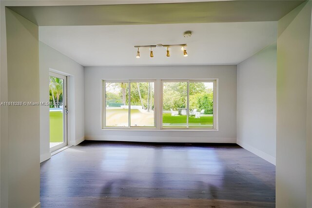 8390 SW 64th St, Miami, FL 33143 - spare room featuring healthy amount of natural light, wood finished floors, and a smoke detector