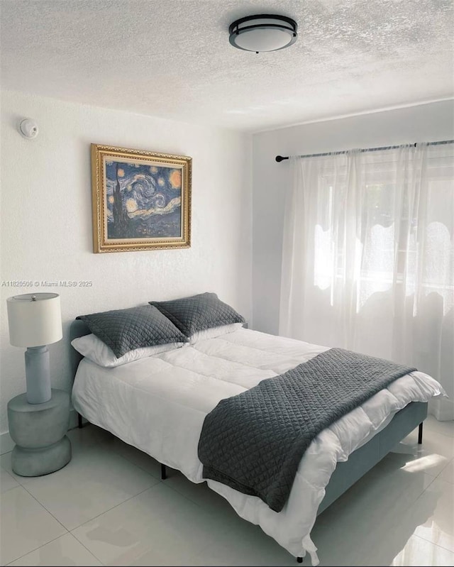 445 SW 11th St Unit 101, Miami, FL 33130 - bedroom featuring a textured ceiling and tile patterned floors
