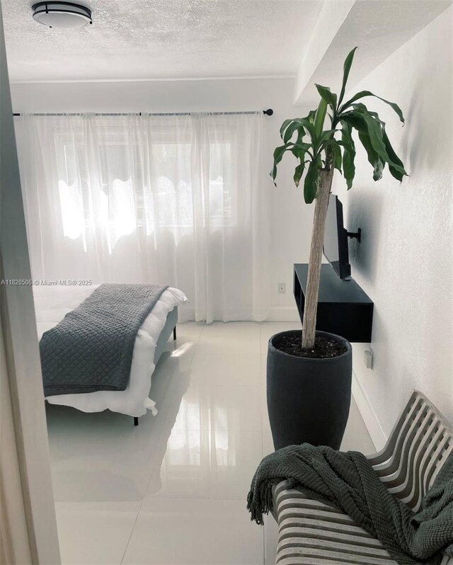 445 SW 11th St Unit 101, Miami, FL 33130 - bedroom with tile patterned flooring and a textured ceiling