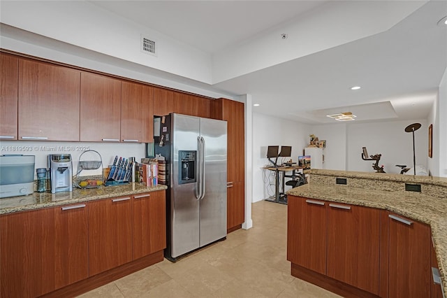 14951 Royal Oaks Ln Unit 803, North Miami, FL 33181 - kitchen featuring stainless steel fridge with ice dispenser, brown cabinets, light stone counters, and recessed lighting
