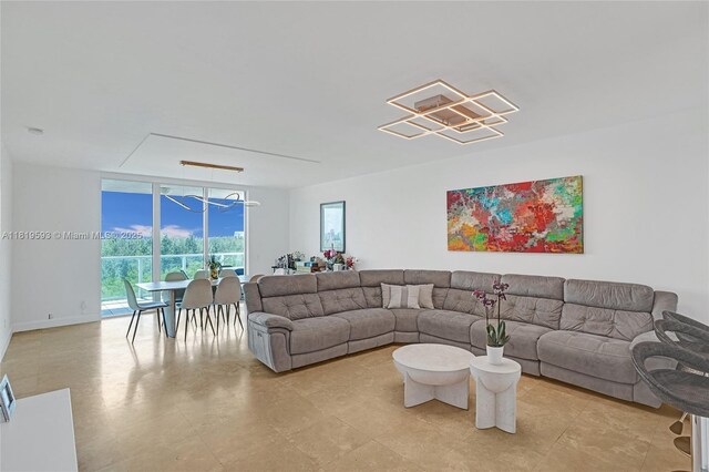 14951 Royal Oaks Ln Unit 803, North Miami, FL 33181 - living area with a chandelier and a wall of windows