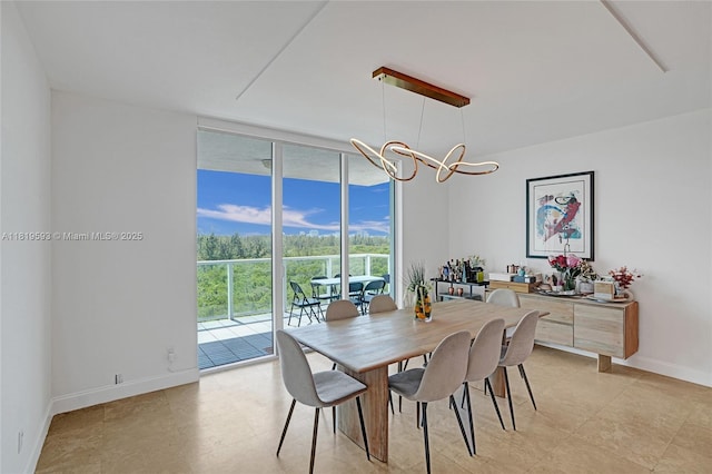 14951 Royal Oaks Ln Unit 803, North Miami, FL 33181 - dining area with a wall of windows, a chandelier, and light tile patterned floors