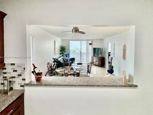 7118 Bonita Dr Unit 405, Miami Beach, FL 33141 - kitchen with backsplash, stone counters, and ceiling fan