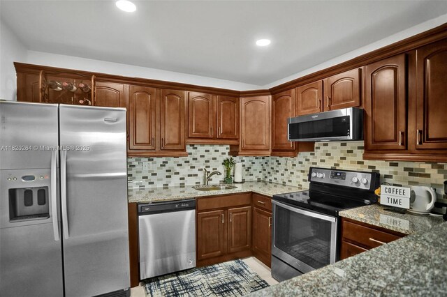 7118 Bonita Dr Unit 405, Miami Beach, FL 33141 - kitchen featuring appliances with stainless steel finishes, light stone counters, decorative backsplash, and recessed lighting