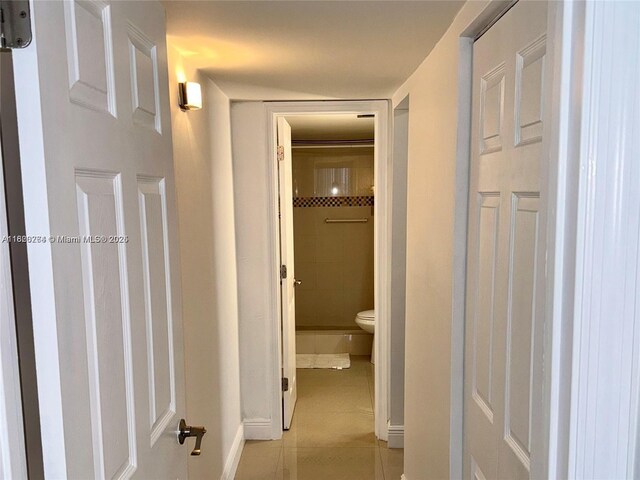 7118 Bonita Dr Unit 405, Miami Beach, FL 33141 - hallway with baseboards and light tile patterned flooring