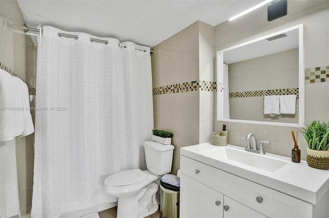7118 Bonita Dr Unit 405, Miami Beach, FL 33141 - bathroom with tile walls, backsplash, vanity, and a shower with curtain