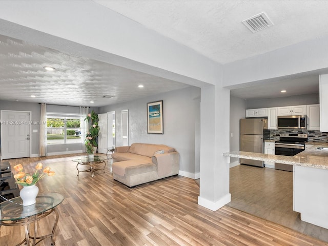 1805 N 23rd Ave, Hollywood, FL 33020 - living room with light wood finished floors, recessed lighting, and a textured ceiling