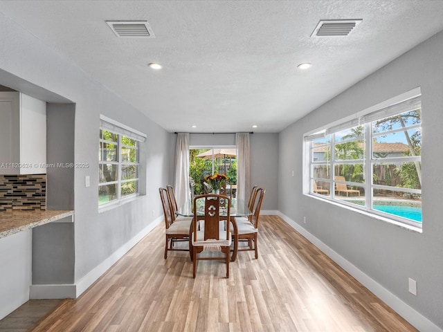 1805 N 23rd Ave, Hollywood, FL 33020 - dining area with light wood-style flooring, a textured ceiling, and recessed lighting