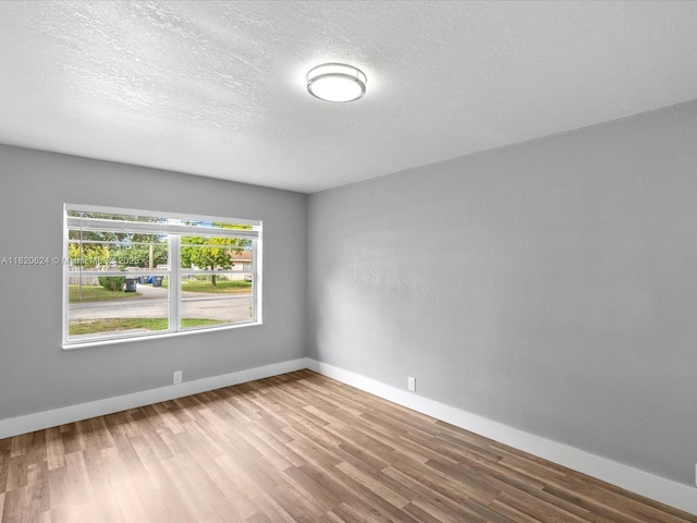 1805 N 23rd Ave, Hollywood, FL 33020 - spare room with wood finished floors and a textured ceiling