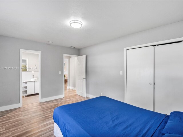 1805 N 23rd Ave, Hollywood, FL 33020 - bedroom with light wood-style floors, a closet, and ensuite bathroom