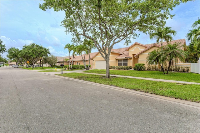 16176 NW 14th Ct, Pembroke Pines, FL 33028 - view of front of home featuring stucco siding, a tiled roof, a garage, and driveway