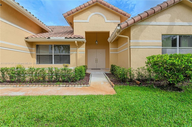 16176 NW 14th Ct, Pembroke Pines, FL 33028 - entrance to property featuring a tile roof, a yard, and stucco siding