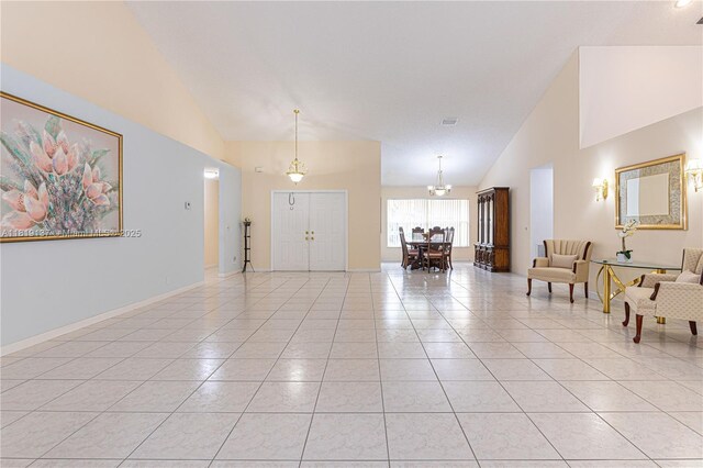 16176 NW 14th Ct, Pembroke Pines, FL 33028 - entryway with high vaulted ceiling, light tile patterned floors, and a chandelier