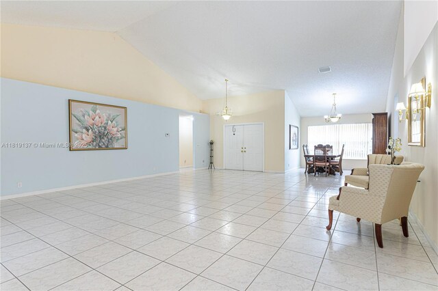 16176 NW 14th Ct, Pembroke Pines, FL 33028 - living room with light tile patterned floors, a chandelier, and high vaulted ceiling