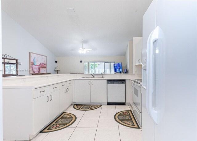16176 NW 14th Ct, Pembroke Pines, FL 33028 - kitchen with white appliances, ceiling fan, light countertops, white cabinets, and lofted ceiling