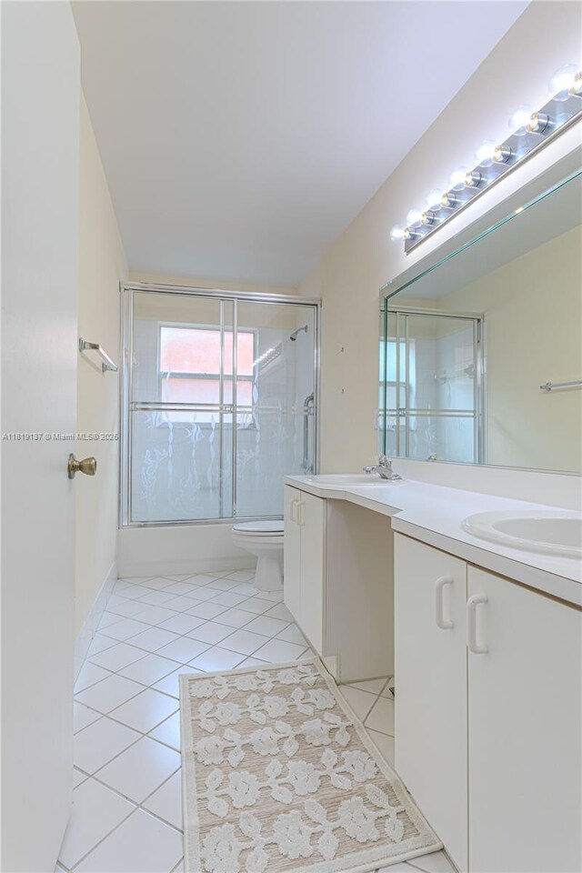 16176 NW 14th Ct, Pembroke Pines, FL 33028 - full bath with double vanity, tile patterned floors, and enclosed tub / shower combo