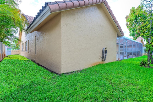 16176 NW 14th Ct, Pembroke Pines, FL 33028 - view of home's exterior with stucco siding, a tiled roof, and glass enclosure
