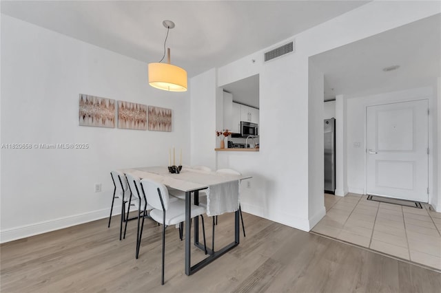 1250 S Miami Ave Unit 2210, Miami, FL 33130 - dining area featuring light wood finished floors