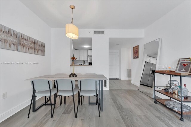 1250 S Miami Ave Unit 2210, Miami, FL 33130 - dining area featuring wood finished floors and baseboards