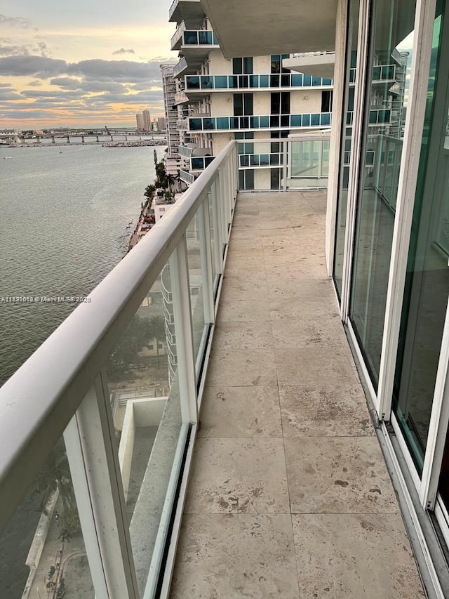 665 NE 25th St Unit 1102, Miami, FL 33137 - balcony at dusk featuring a water view