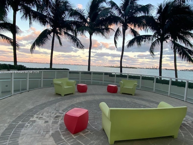 665 NE 25th St Unit 1102, Miami, FL 33137 - patio terrace at dusk featuring a water view and a patio area