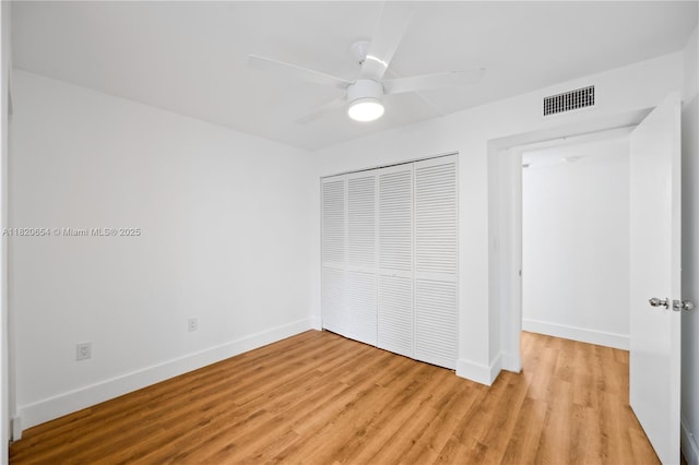 1440 Brickell Bay Unit 307, Miami, FL 33131 - unfurnished bedroom with a closet, light wood-type flooring, and a ceiling fan