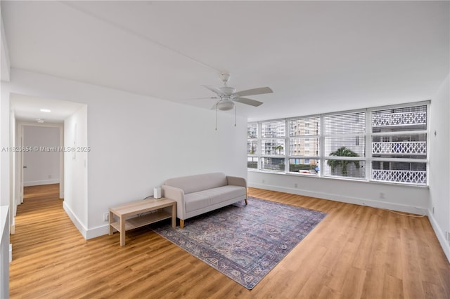 1440 Brickell Bay Unit 307, Miami, FL 33131 - sitting room with light wood-style floors and a ceiling fan