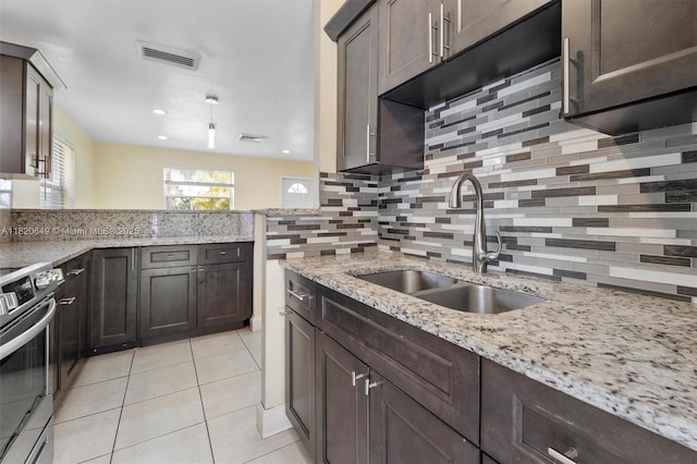 602 El Prado, West Palm Beach, FL 33405 - kitchen featuring stainless steel stove, tasteful backsplash, dark brown cabinetry, light stone counters, and recessed lighting