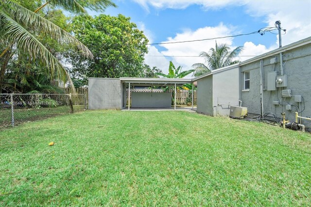 602 El Prado, West Palm Beach, FL 33405 - fenced backyard featuring a carport