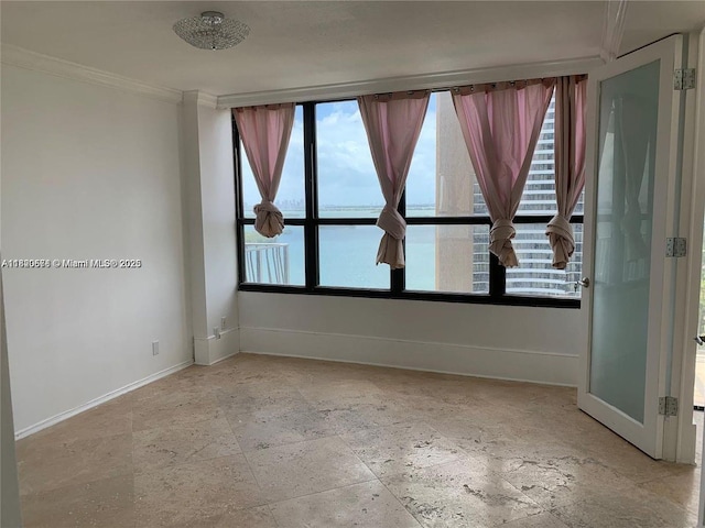780 NE 69th St Unit 1507, Miami, FL 33138 - empty room featuring stone tile floors, ornamental molding, and healthy amount of natural light