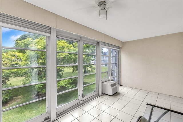 2026 Berkshire B 2026, Deerfield Beach, FL 33442 - unfurnished sunroom featuring tile patterned flooring and an AC wall unit