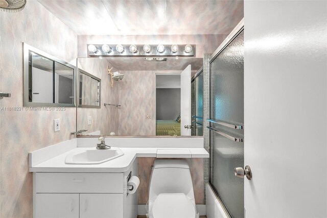 2026 Berkshire B 2026, Deerfield Beach, FL 33442 - ensuite bathroom with vanity and bath / shower combo with glass door