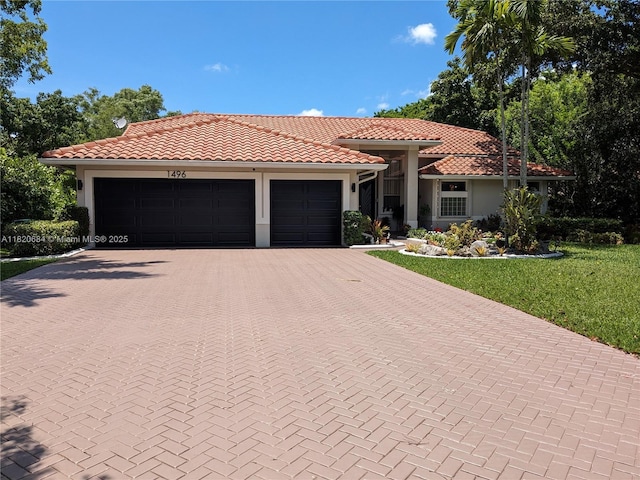 1496 NW 127th Way, Coral Springs, FL 33071 - mediterranean / spanish home featuring decorative driveway, an attached garage, a tile roof, a front yard, and stucco siding