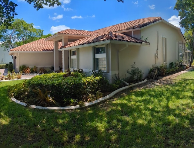 1496 NW 127th Way, Coral Springs, FL 33071 - view of side of home with a tiled roof, a yard, and stucco siding