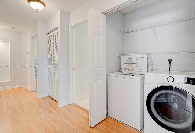 4801 SW 158th Ave, Miramar, FL 33027 - washroom with washing machine and clothes dryer and light wood-style floors