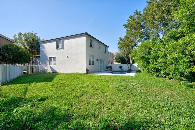 4801 SW 158th Ave, Miramar, FL 33027 - back of property featuring stucco siding, a fenced backyard, and a patio