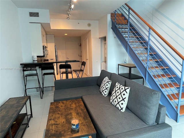60 SW 13th St Unit 2606, Miami, FL 33130 - living room with stairway, rail lighting, and tile patterned floors